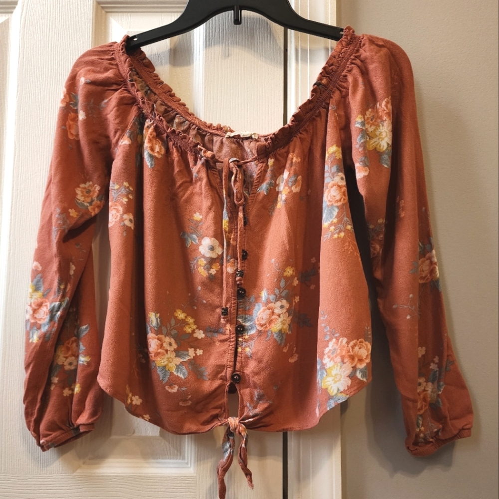 Off the shoulder, long sleeve shirt that stops right at the waist